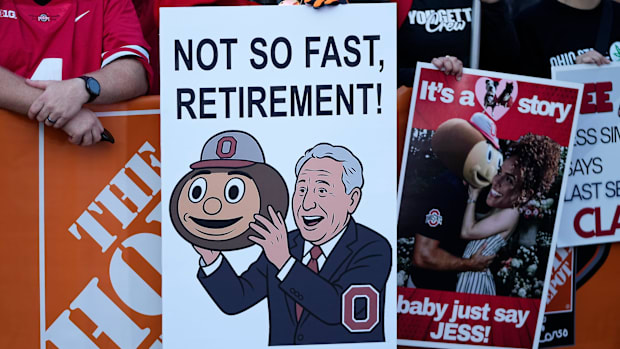 A fan holds a sign celebrating Lee Corso’s career at ‘College GameDay.’