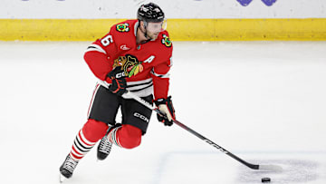 Nov 19, 2024; Chicago, Illinois, USA; Chicago Blackhawks center Jason Dickinson (16) controls the puck against the Anaheim Ducks during the third period at United Center. Mandatory Credit: Kamil Krzaczynski-Imagn Images