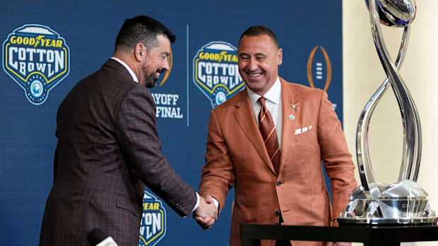 Ohio State Buckeyes head coach Ryan Day and Texas Longhorns head coach Steve Sarkisian shake hands following a press conferen