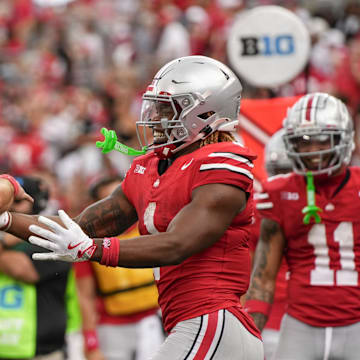 Aug 31, 2024; Columbus, OH, USA; Ohio State Buckeyes running back Quinshon Judkins (1) celebrates scoring a touchdown with quarterback Will Howard (18) during the NCAA football game against the Akron Zips at Ohio Stadium. Ohio State won 52-6.