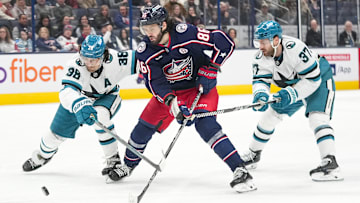 Jan 16, 2025; Columbus, Ohio, USA; Columbus Blue Jackets right wing Kirill Marchenko (86) shoots the puck against San Jose Sharks defenseman Mario Ferraro (38) and defenseman Timothy Liljegren (37) in the third period at Nationwide Arena on Thursday, Jan. 16, 2025 in Columbus, Ohio.   Mandatory Credit: Samantha Madar/USA TODAY Network via Imagn Images 