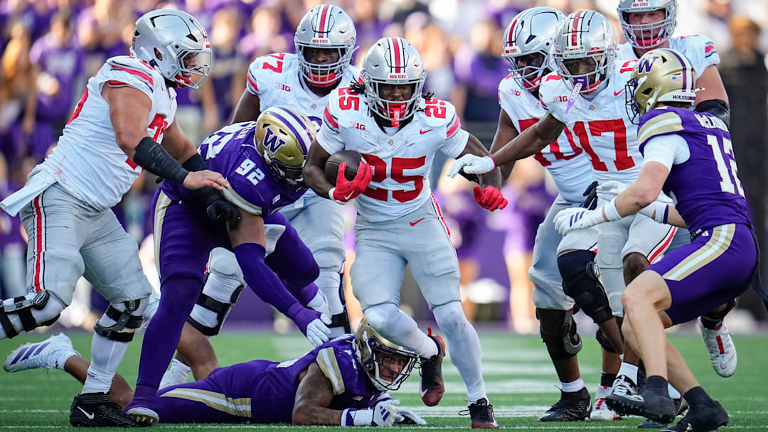 Ohio State Buckeyes running back Bo Jackson (25) runs over Washington Huskies linebacker Xe'ree Alexander (10) and defensive lineman Bryce Butler (92) during the NCAA football game at Husky Stadium in Seattle on Sept. 27, 2025. Ohio State won 24-6.