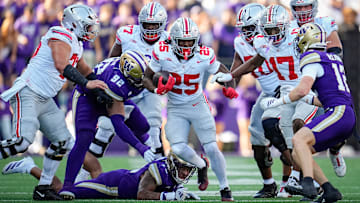 Ohio State Buckeyes running back Bo Jackson (25) runs over Washington Huskies linebacker Xe'ree Alexander (10) and defensive lineman Bryce Butler (92) during the NCAA football game at Husky Stadium in Seattle on Sept. 27, 2025. Ohio State won 24-6.