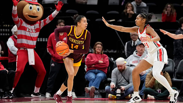 Ohio State Buckeyes guard Chance Gray (21) defends Minnesota Golden Gophers guard Tori McKinney (14) with sideline help from 