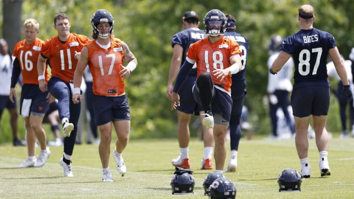 Caleb Williams leads the quarterbacks through warmups during Bears minicamp. Their playoff chances could hinge mostly on how well they've improved the offense.