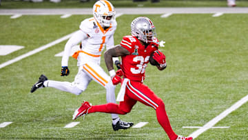 Ohio State Buckeyes running back TreVeyon Henderson (32) runs the ball against Tennessee Volunteers defensive back Rickey Gibson III (1) in the second half at Ohio Stadium on Saturday, Dec. 21, 2024 in Columbus, Ohio.