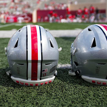 Sep 2, 2023; Bloomington, Indiana, USA; Ohio State Buckeyes helmets sit on the sideline prior to the NCAA football game at Indiana University Memorial Stadium.