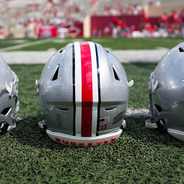 Sep 2, 2023; Bloomington, Indiana, USA; Ohio State Buckeyes helmets sit on the sideline prior to the NCAA football game at Indiana University Memorial Stadium.