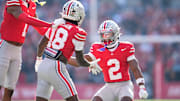 Ohio State Buckeyes cornerback Davison Igbinosun (1) and defensive back Caleb Downs (2) celebrate with safety Jaylen McClain (18) during the first half of the NCAA football game against the Rutgers Scarlet Knights at Ohio Stadium in Columbus on Nov. 22, 2025.