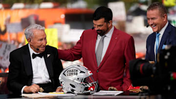 Ohio State Buckeyes head coach Ryan Day presents Lee Corso with a helmet beside Kirk Herbstreit on the set of ESPN College GameDay prior to the NCAA football game between the Ohio State Buckeyes and the Texas Longhorns at Ohio Stadium on Aug. 30, 2025.