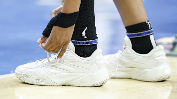 Jul 12, 2025; Chicago, Illinois, USA; Chicago Sky forward Angel Reese (5) ties her Reebok shoes during the first half of a WNBA game against the Minnesota Lynx at Wintrust Arena. Mandatory Credit: Kamil Krzaczynski-Imagn Images