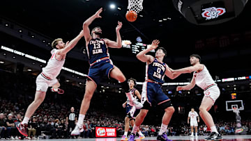 Ohio State Buckeyes forward Brandon Noel (14) fights for a rebound with Illinois Fighting Illini center Tomislav Ivisic (13) an dforward David Mirkovic (0) during the first half of the NCAA men's basketball game in Columbus on Dec. 9, 2025.