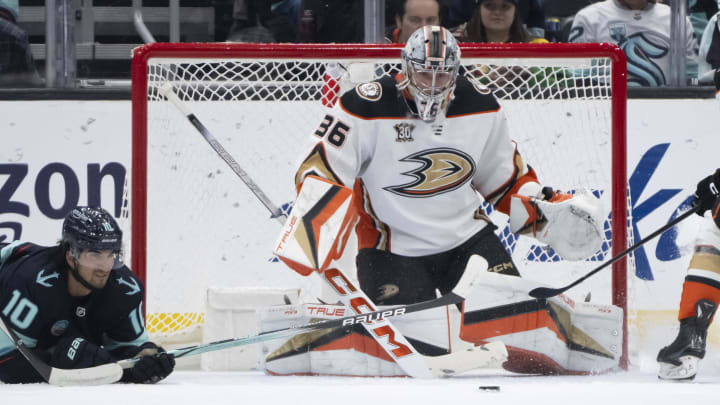 Mar 26, 2024; Seattle, Washington, USA; The puck sits in front of Anaheim Ducksgoalie John Gibson (36) and. Seattle Kraken forward Matty Beniers (10) during the first period at Climate Pledge Arena. Mandatory Credit: Stephen Brashear-USA TODAY Sports