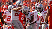 Ohio State Buckeyes linebacker Garrett Stover (23) celebrates a tackle by cornerback Bryce West (12) on a kickoff during the NCAA football game against the Illinois Fighting Illini at Gies Memorial Stadium in Champaign on Oct. 11, 2025. Ohio State won 34-16.