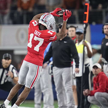 Ohio State Buckeyes wide receiver Carnell Tate (17) makes a sideline catch in front of Texas Longhorns defensive back Malik Muhammad (5) during the first half of the Cotton Bowl Classic College Football Playoff semifinal game at AT&T Stadium in Arlington, Texas on Jan. 10, 2025.