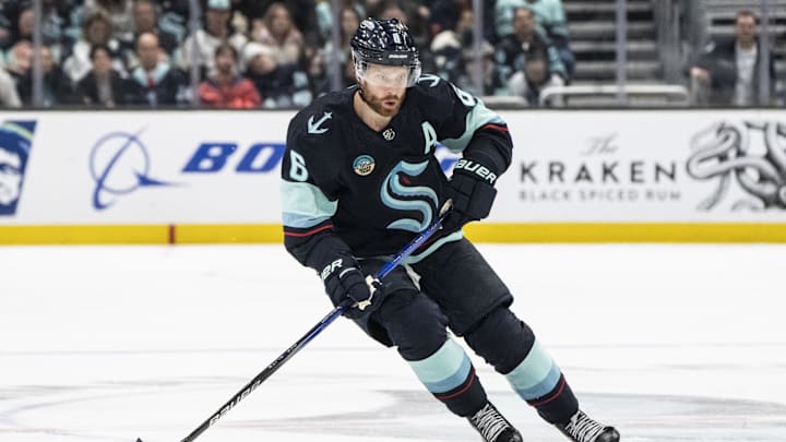 Apr 11, 2024; Seattle, Washington, USA; Seattle Kraken defenseman Adam Larsson (6) skates with the puck against the San Jose Sharks at Climate Pledge Arena. Mandatory Credit: Stephen Brashear-Imagn Images