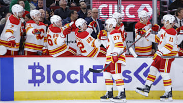 Jan 13, 2025; Chicago, Illinois, USA; Calgary Flames right wing Matt Coronato (27) celebrates with teammates after scoring against the Chicago Blackhawks during the first period at United Center. Mandatory Credit: Kamil Krzaczynski-Imagn Images