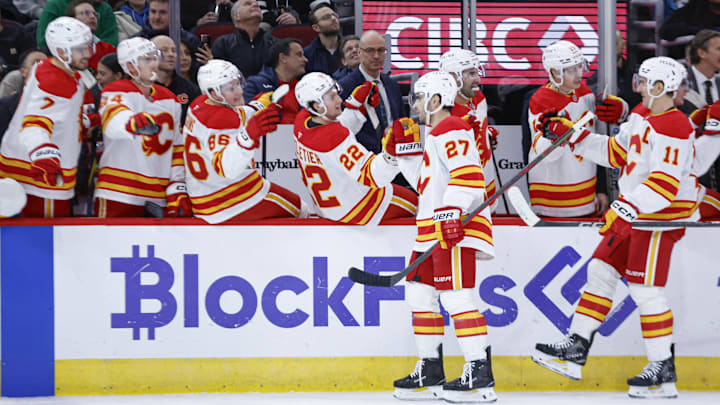 Jan 13, 2025; Chicago, Illinois, USA; Calgary Flames right wing Matt Coronato (27) celebrates with teammates after scoring against the Chicago Blackhawks during the first period at United Center. Mandatory Credit: Kamil Krzaczynski-Imagn Images