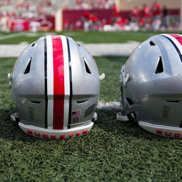 Sep 2, 2023; Bloomington, Indiana, USA; Ohio State Buckeyes helmets sit on the sideline prior to the NCAA football game at Indiana University Memorial Stadium.