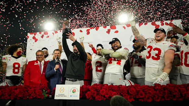 Ohio State Buckeyes head coach Ryan Day hosts the Leishman Trophy following the 41-21 win over the Oregon Ducks in the Colleg
