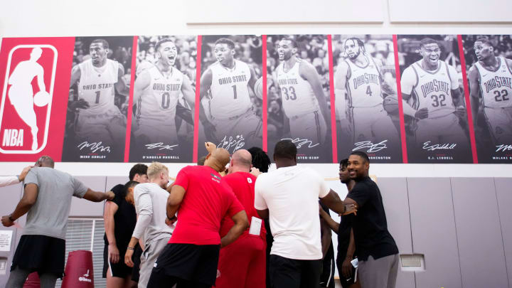 Jul 9, 2024; Columbus, OH, USA; Pictures of recent NBA players hang on the wall of the practice gym over the as the Ohio State Buckeyes men’s basketball team huddles during a summer workout in the practice gym at the Schottenstein Center.
