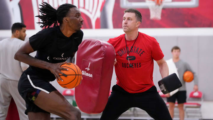 Ohio State Buckeyes head coach Jake Diebler uses pads to defend forward Aaron Bradshaw during a summer workout in the practice gym at the Schottenstein Center.