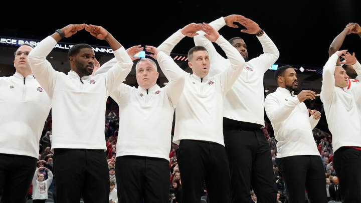 Mar 19, 2024; Columbus, OH, USA; Ohio State Buckeyes head coach Jake Diebler and his assistants sing    Carmen Ohio    during the second half of the NIT basketball game at Value City Arena.