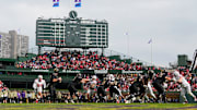 Northwestern Wildcats quarterback Jack Lausch (12) drops back to pass during the first half of the NCAA football game against the Ohio State Buckeyes at Wrigley Field in Chicago on Saturday, Nov. 16, 2024.