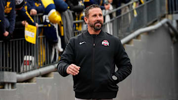 Ohio State Buckeyes offensive coordinator Brian Hartline laughs after hearing jeers as he walks onto the field prior to the NCAA football game against the Michigan Wolverines at Michigan Stadium in Ann Arbor, Mich. on Nov. 29, 2025.