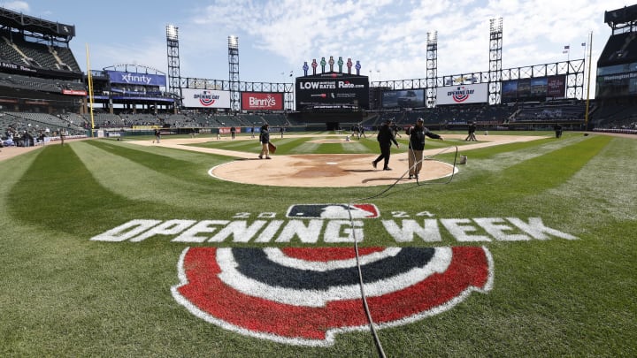 Grounds crew workers prepare the field for an MLB Opening Day in Chicago. 