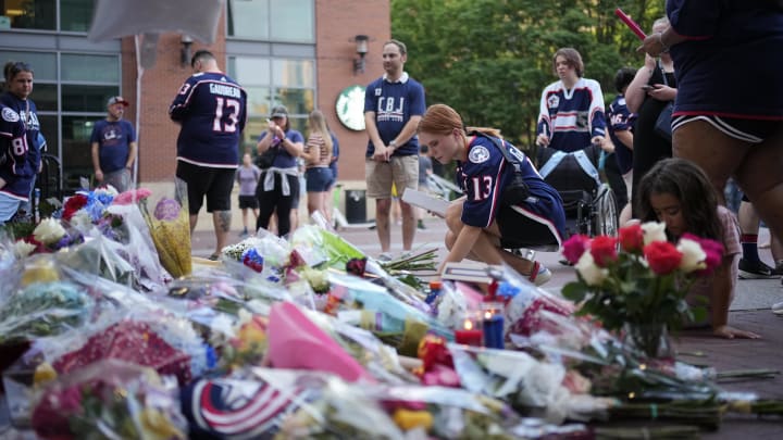 Aug 30, 2024; Columbus, OH, USA; Mourners leave notes, flowers and candles outside Nationwide Arena at a makeshift memorial for Columbus Blue Jackets forward Johnny Gaudreau. Gaudreau and his brother, Matthew, were killed in a bicycle accident the night before. Mandatory Credit: Adam Cairns/Columbus Dispatch-USA TODAY Network