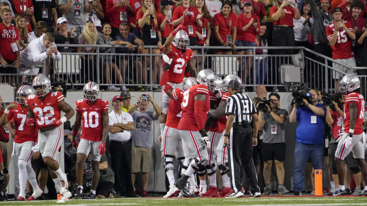 Sep 3, 2022; Columbus, Ohio, USA; Ohio State Buckeyes offensive lineman Paris Johnson Jr. (77) hoists wide receiver Emeka Egbuka (2) after he scored a touchdown during the NCAA football game against the Notre Dame Fighting Irish at Ohio Stadium. Mandatory Credit: Adam Cairns-USA TODAY Sports