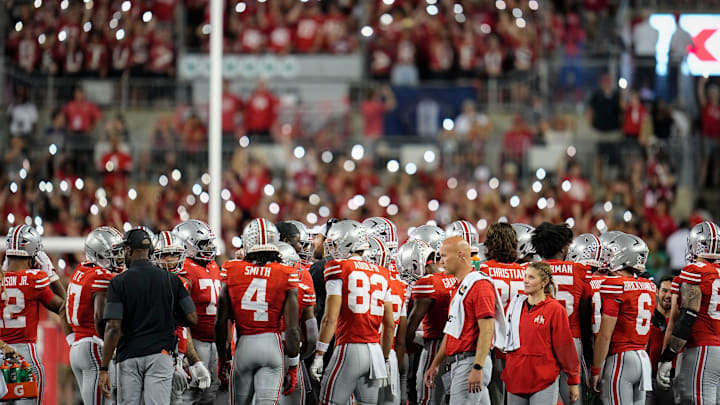 The Block O student section lights up the stadium with cell phone lights during a game against the Ohio Bobcats