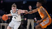 Vanderbilt Commodores guard Grant Huffman (4) drives against Tennessee Volunteers guard Chaz Lanier (2) during their game at Memorial Gym in Nashville, Tenn., Saturday, Jan. 18, 2025.