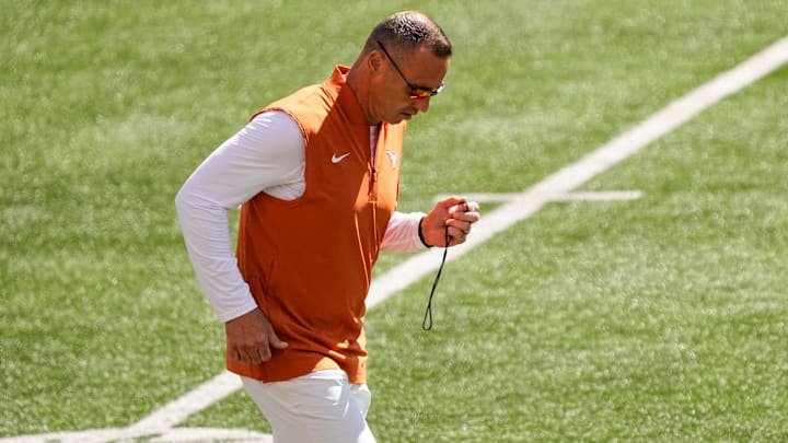 Texas Longhorns head coach Steve Sarkisian runs across the field during warm-ups prior to the NCAA football game against the Ohio State Buckeyes. Texas Longhorns head coach Steve Sarkisian runs across the field during warm-ups prior to the NCAA football game against the Ohio State Buckeyes.