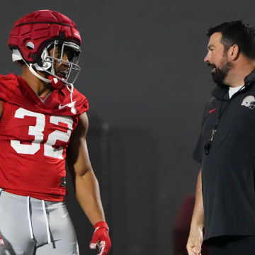 Mar 7, 2024; Columbus, OH, USA; Ohio State Buckeyes head coach Ryan Day talks to running back TreVeyon Henderson (32) during spring football practice at the Woody Hayes Athletic Center.