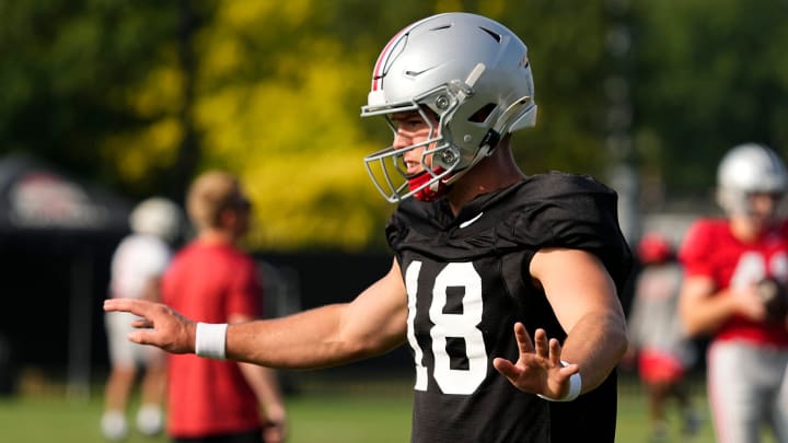 Aug 8, 2024; Columbus, Ohio, USA; Ohio State Buckeyes quarterback Will Howard (18) takes a snap during football practice at the Woody Hayes Athletic Complex.