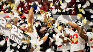 Ohio State Buckeyes head coach Ryan Day and players celebrate with the trophy following the 34-23 win over the Notre Dame Fighting Irish to win the College Football Playoff National Championship at Mercedes-Benz Stadium in Atlanta on Jan. 22, 2025.