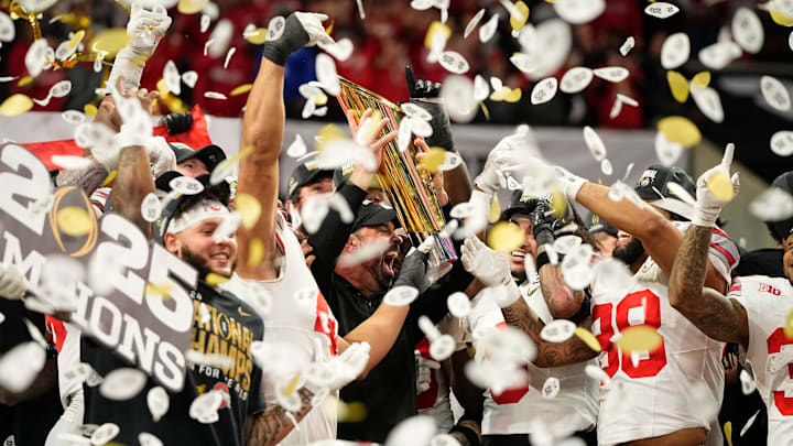 Ohio State Buckeyes head coach Ryan Day and players celebrate with the trophy following the 34-23 win over the Notre Dame Fighting Irish to win the College Football Playoff National Championship at Mercedes-Benz Stadium in Atlanta on Jan. 22, 2025.