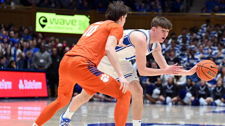 Feb 14, 2026; Durham, North Carolina, USA; Duke Blue Devils forward Nikolas Khamenia (14) controls the ball in front of Clemson Tigers forward Jake Whalin (10) during the second half at Cameron Indoor Stadium. Mandatory Credit: Rob Kinnan-Imagn Images