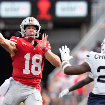 Aug 31, 2024; Columbus, OH, USA; Ohio State Buckeyes quarterback Will Howard (18) throws a pass over Akron Zips defensive lineman Kam Cheatom (22) during the first half of the NCAA football game at Ohio Stadium.