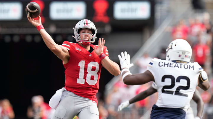 Aug 31, 2024; Columbus, OH, USA; Ohio State Buckeyes quarterback Will Howard (18) throws a pass over Akron Zips defensive lineman Kam Cheatom (22) during the first half of the NCAA football game at Ohio Stadium.