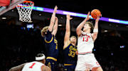 Ohio State Buckeyes center Christoph Tilly (13) hits the game-winning shot over Notre Dame Fighting Irish forward Carson Towt (33) and forward Garrett Sundra (12) during the men's NCAA basketball game at Value City Arena in Columbus on Nov. 16, 2025. Ohio State won 64-63.