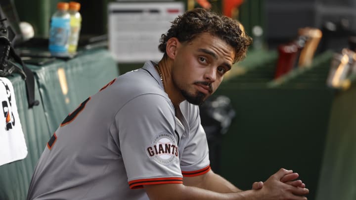 Jun 17, 2024; Chicago, Illinois, USA; San Francisco Giants starting pitcher Jordan Hicks (12) sits in the dugout during the third inning of a baseball game against the Chicago Cubs at Wrigley Field.
