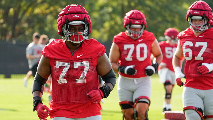 Aug 1, 2024; Columbus, OH, USA; Ohio State Buckeyes offensive lineman Tegra Tshabola (77) runs during football camp at the Woody Hayes Athletic Complex.