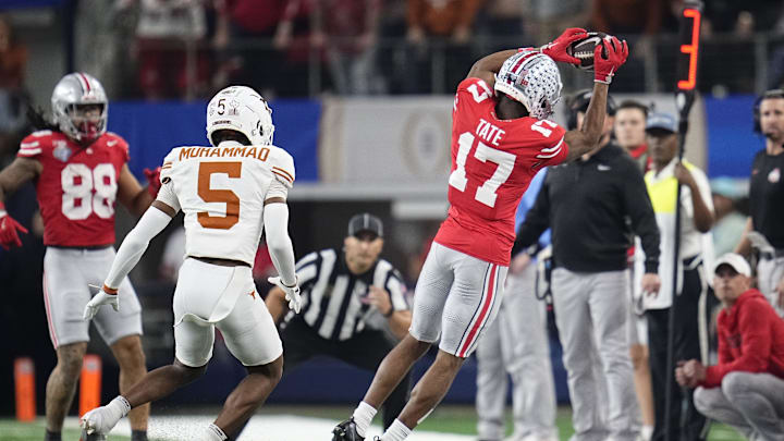 Ohio State Buckeyes WR Carnell Tate catches near Texas Longhorns corner Malik Muhammad during the College Football Playoff