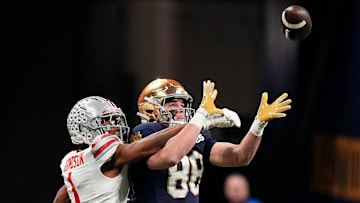 Ohio State Buckeyes cornerback Davison Igbinosun (1) attempts to break up a pass intended for Notre Dame Fighting Irish tight end Mitchell Evans (88) during the College Football Playoff championship at Mercedes-Benz Stadium in Atlanta on Jan. 20, 2025.
