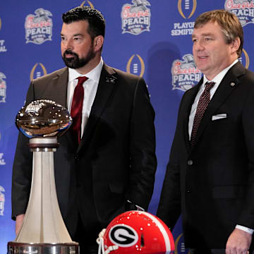 Dec 30, 2022; Atlanta, GA, USA;  Ohio State Buckeyes head coach Ryan Day and Georgia Bulldogs head coach Kirby Smart stand with the George P. Crumbley Trophy following a press conference prior to the Peach Bowl College Football Playoff semifinal at the Westin Hotel in Atlanta. Mandatory Credit: Adam Cairns-The Columbus Dispatch

Football Ohio State Georgia Coaches Press Conference