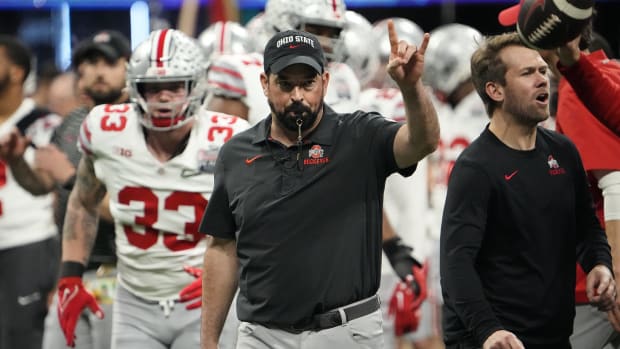 Head coach leads team out of tunnel.