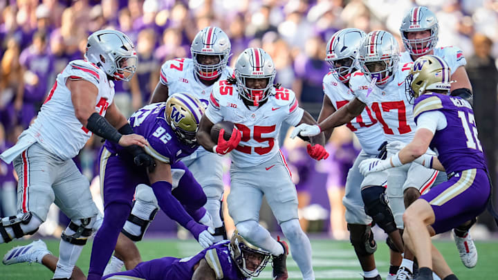 Ohio State Buckeyes running back Bo Jackson (25) runs over Washington Huskies linebacker Xe'ree Alexander (10) and defensive lineman Bryce Butler (92) during the NCAA football game at Husky Stadium in Seattle on Sept. 27, 2025. Ohio State won 24-6.
